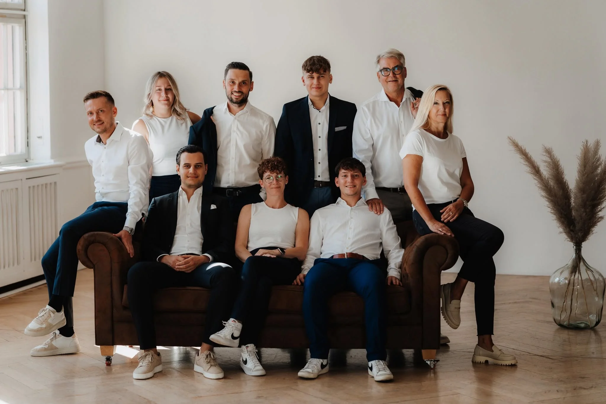 Das Team der R. Bächle OHG aus Offenburg: neun Kolleginnen und Kollegen um ein braunes Ledersofa in einem hellen Raum